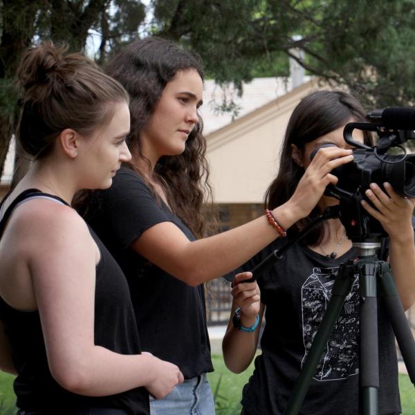 Katia Kanner adjusts the camera for a shot with her group mates. 