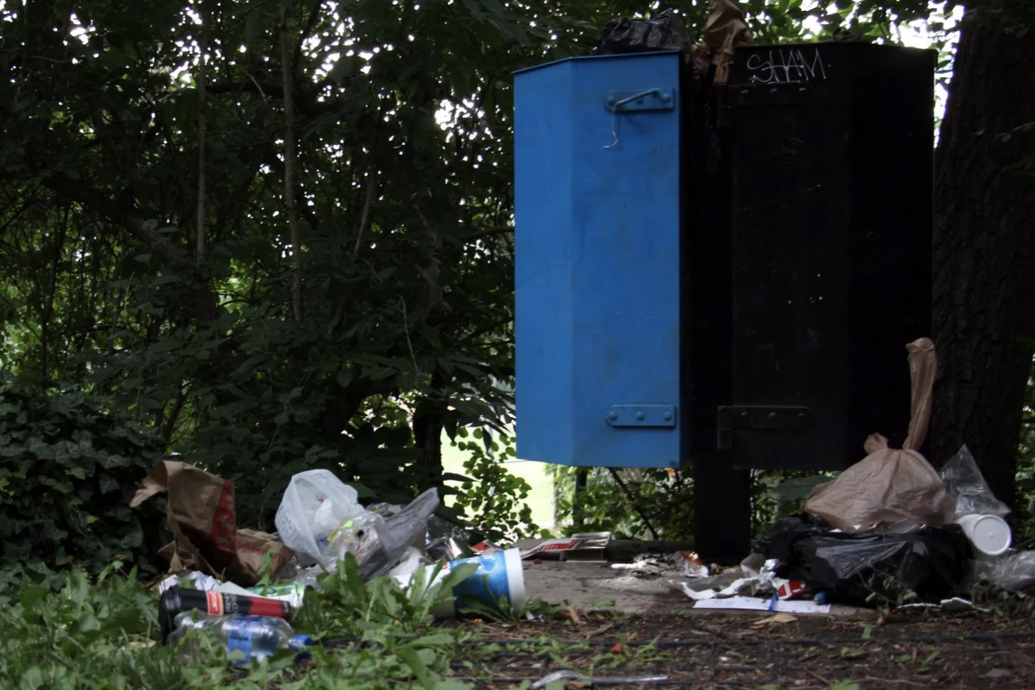 A trashcan overflows and becomes surrounded by trash off of a path behind CU Boulder’s College of Media, Communication and Information. The United States is the number one trash producer in the world, generating 254 million tons of trash in 2013.
