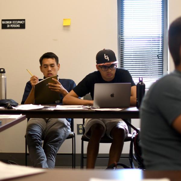 Austin Mann takes notes during an academic skills session.