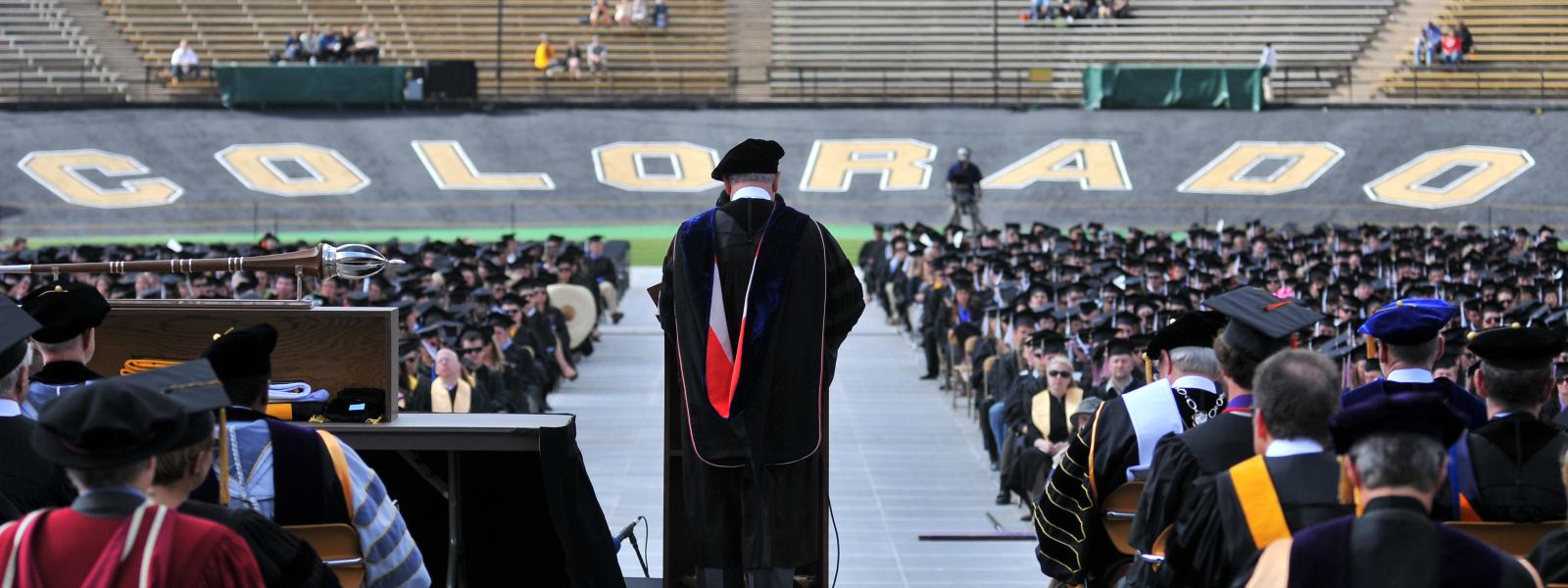From Chancellor's point-of-view speaking in front of a crowd of graduating students at Folsom Field.