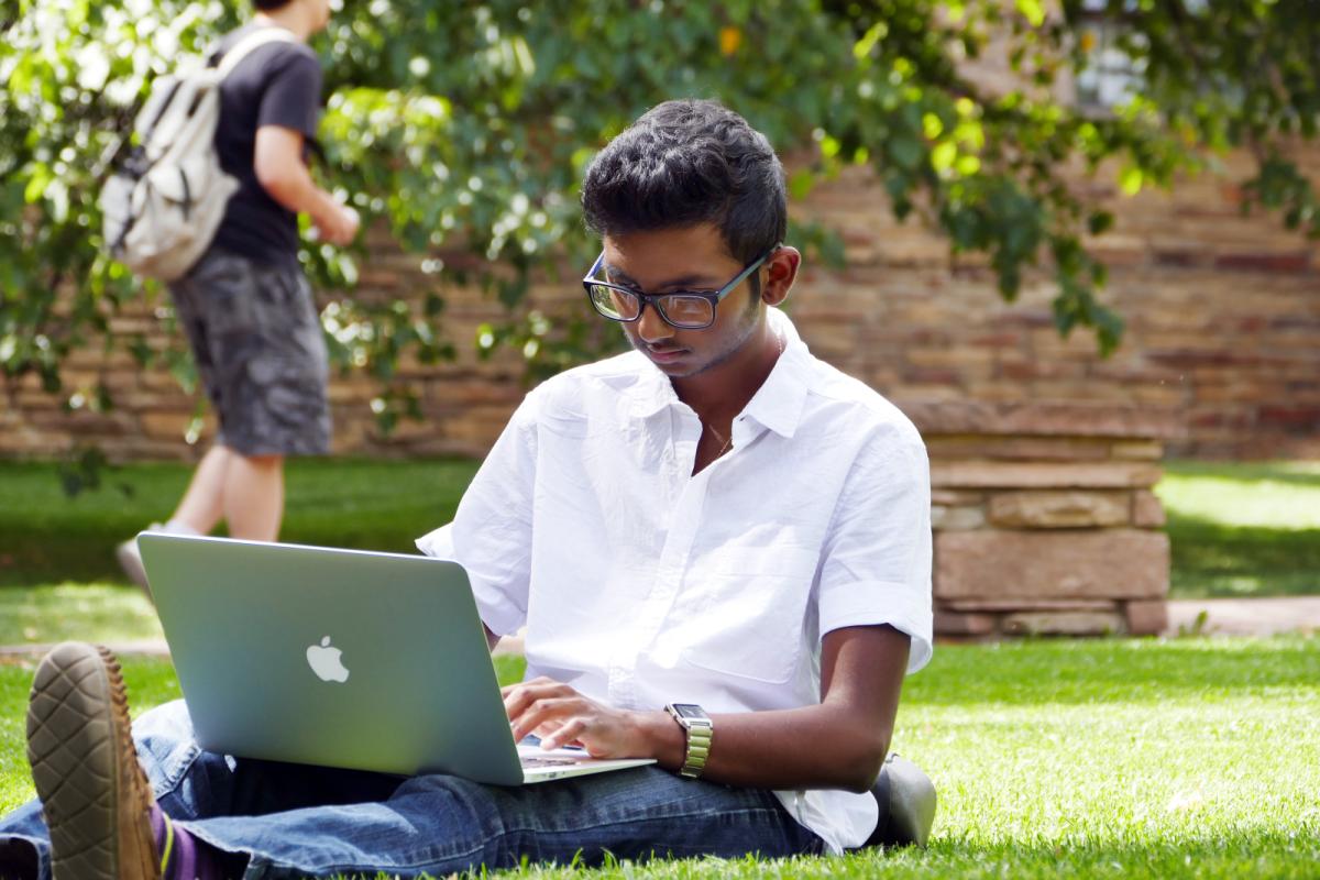 Student uses laptop outside