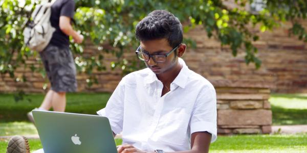 Student uses laptop outside