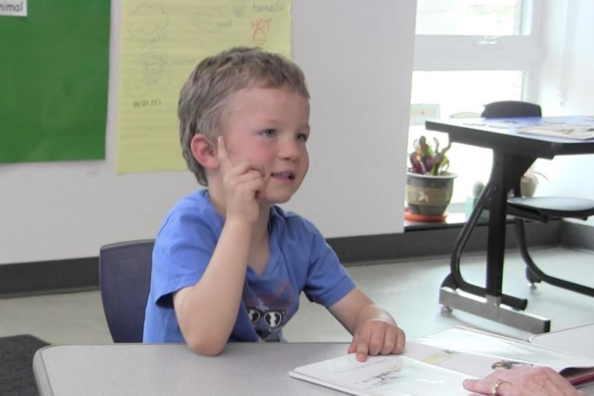student fingerspelling showing the handshake "U"