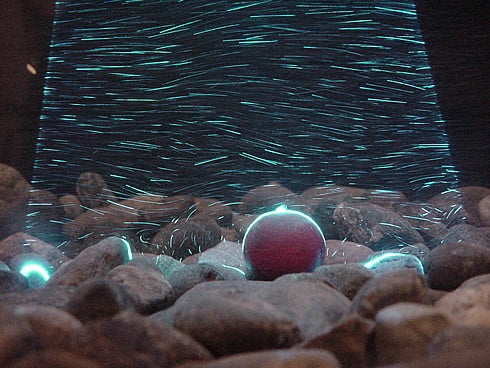 Laser light sheet illuminating sediment transport in a sediment flume.