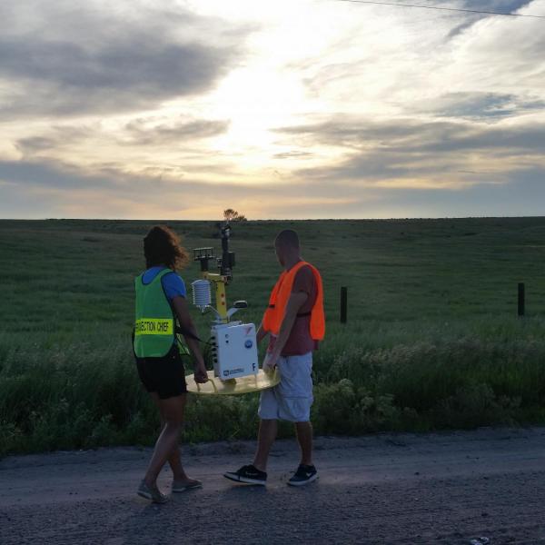 CSWR intern students deploying a weather "pod" on a county road in Kansas/Nebraska in preparation for a passing convective system as part of the PECAN project on 1 June 2015. The weather pod collects meteorological data (wind, temperature, dew point, pressure), which will later be analyzed by graduate students and researchers to understand how nocturnal thunderstorms behave.