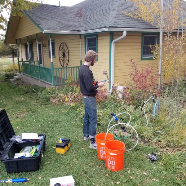 Graduate student, John Stults, working on a well water project in east Boulder County.