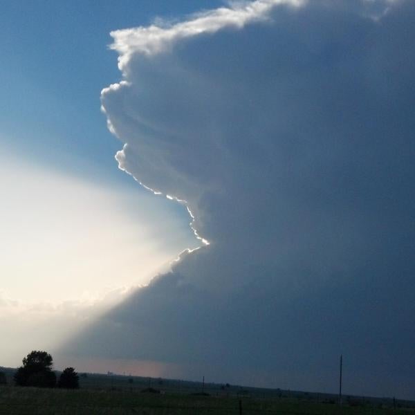 A supercell thunderstorm on the plains of Kansas on 19 May 2013. The outline of the cumulonimbus cloud is highlighted by the sun.