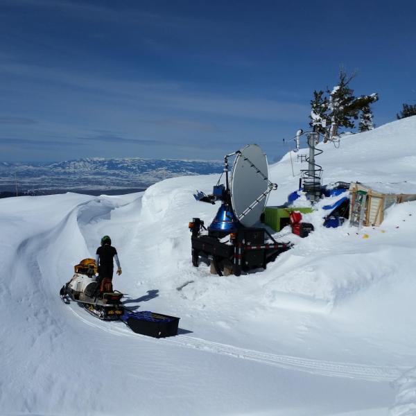 A CSWR Doppler On Wheels (DOW) mobile radar positioned at the Snowbank mountaintop location (8,000 ft elevation) on 12 March 2017 as part of the SNOWIE field project. The DOW radar was used to collect data on seeded and natural clouds and snowfall between January and March 2017. The only access to the site was via snowmobile. The site was so buried by snow that tunnels were dug to access the trailer, porta potties, and radar truck.