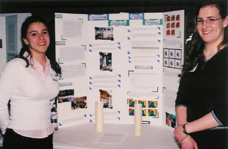 2 female students posing in front of research display