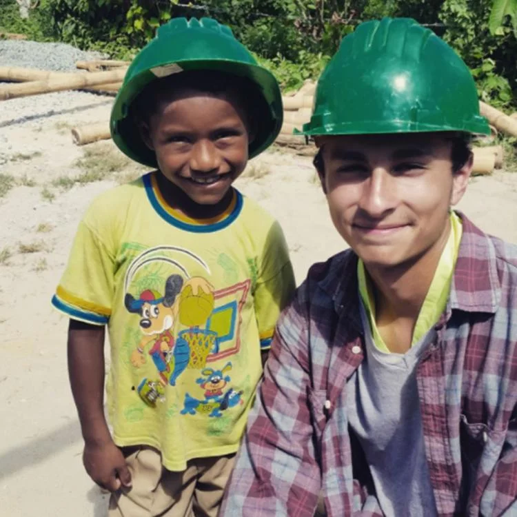 Elijah Gonzales and young child with green construction hats on