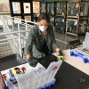 Rachel Sharpe conducts maintenance on one of the 3D printers.