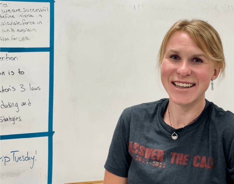 Katie Ryan as a teacher in front of a white board