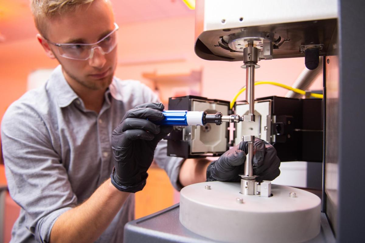 Student adjusting equipment