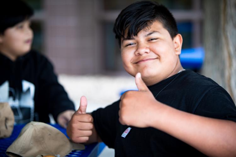 student with thumbs up