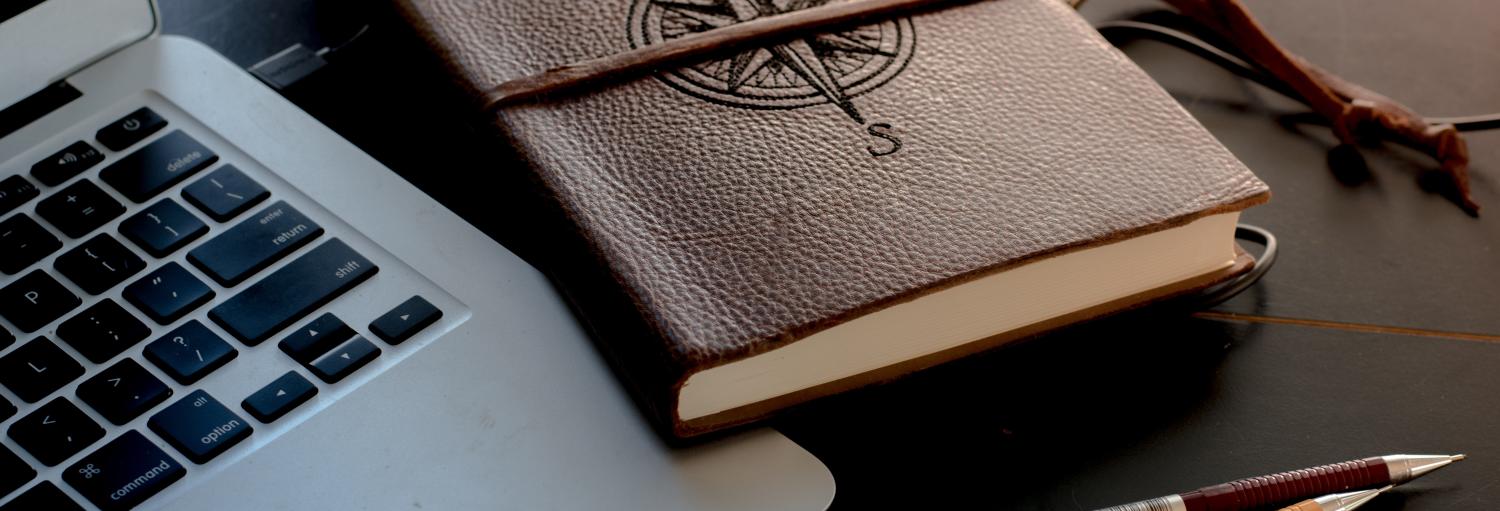 Laptop, journal, pen, pencil