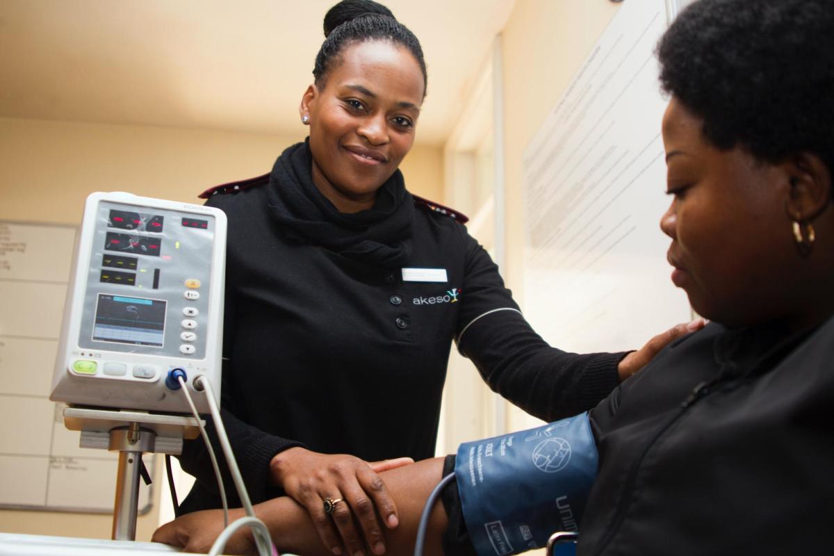 A doctor visits a patient at bedside