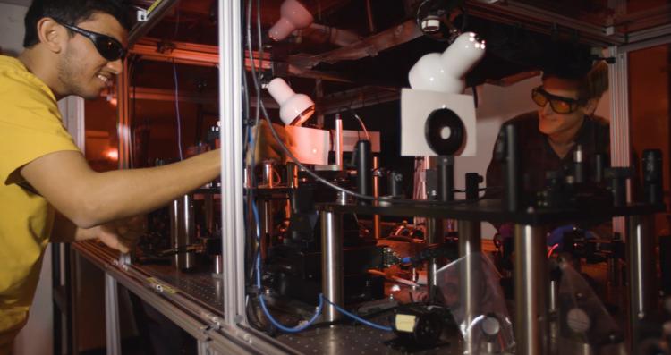 Students in the lab working with lasers