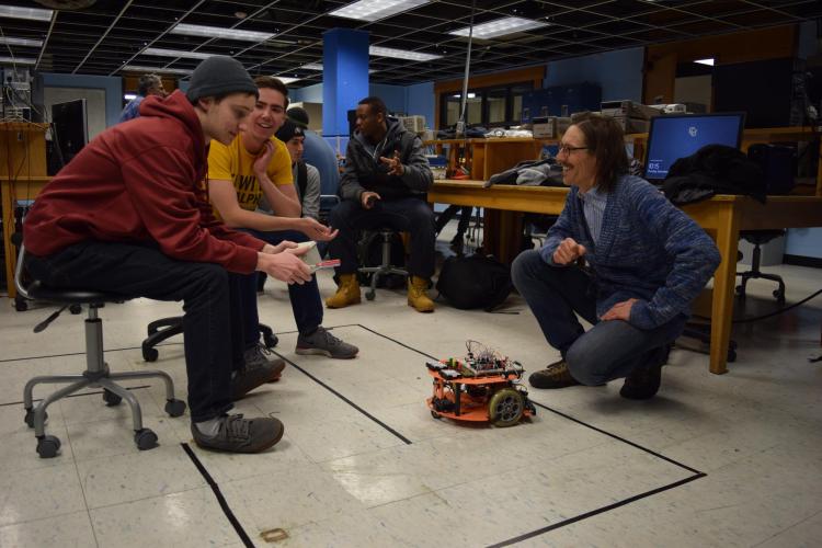 Students with robots on the ground