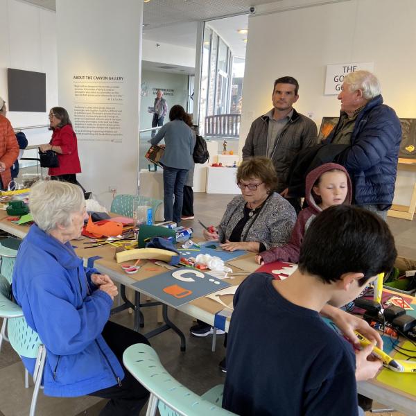 Visitors working on the tactile alphabet
