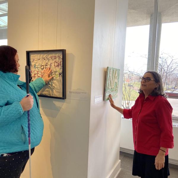 Artists Jenni Holcomb and Ann Cunningham with Jenni's embroidered sampler.