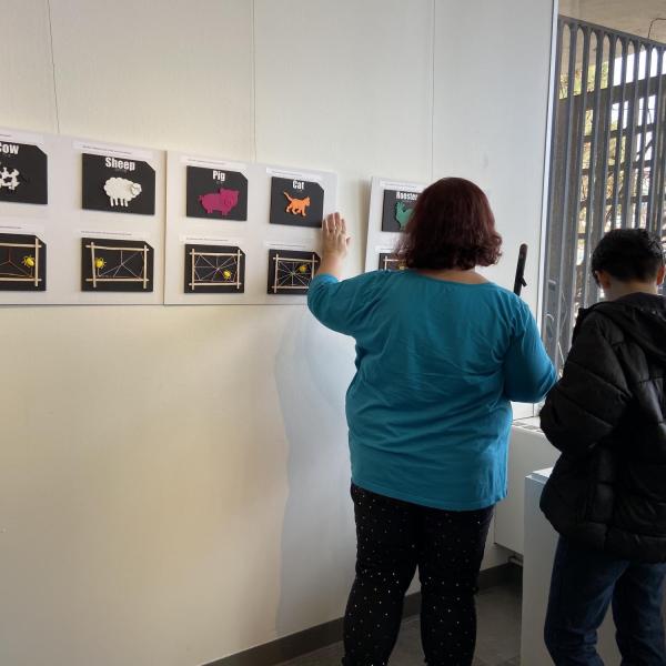Artist Jenni Holcomb exploring tactile pages from The Very Busy Spider.