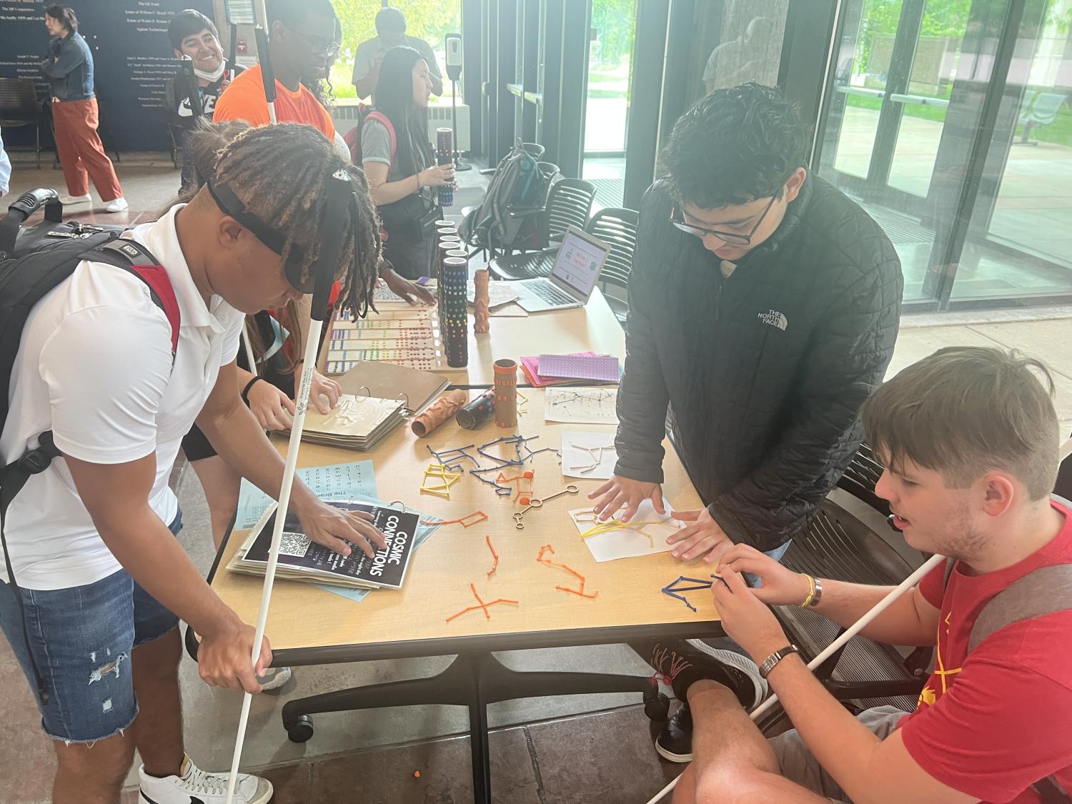 3 people around a table with 3d printed constellations
