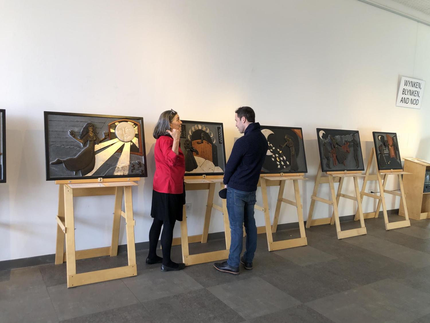 Ann Cunningham standing in front of tactile art panels from her piece Giricoccola