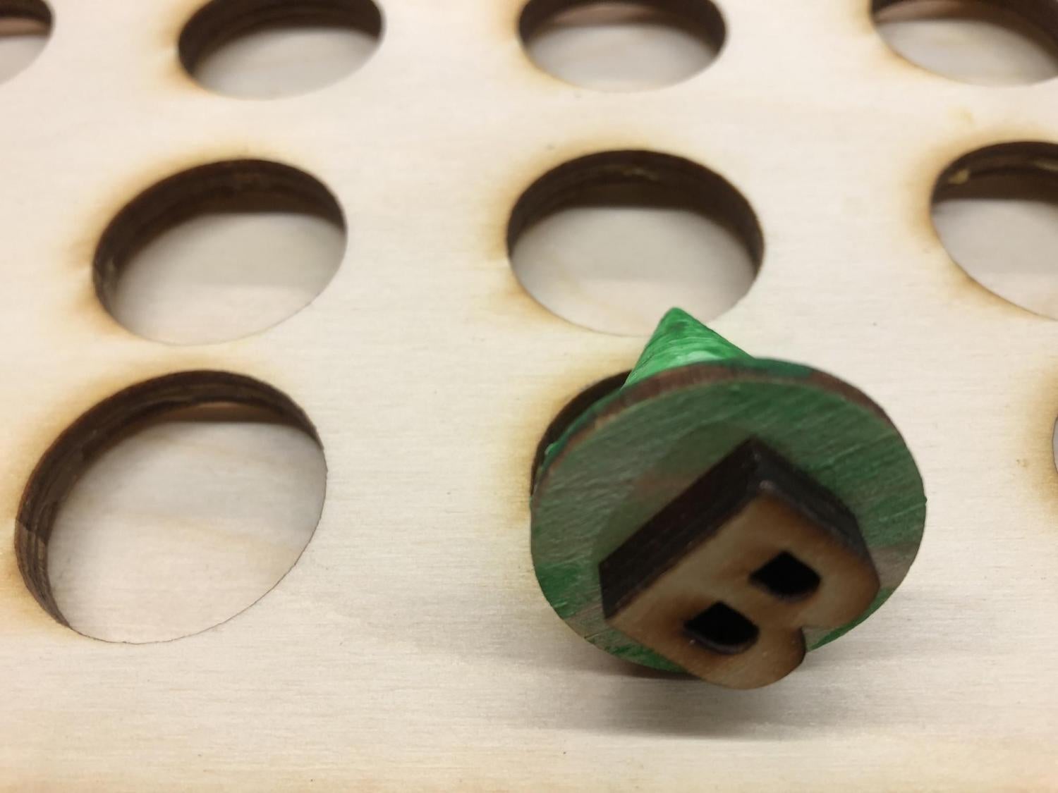 Underside of playing piece showing the letter B.