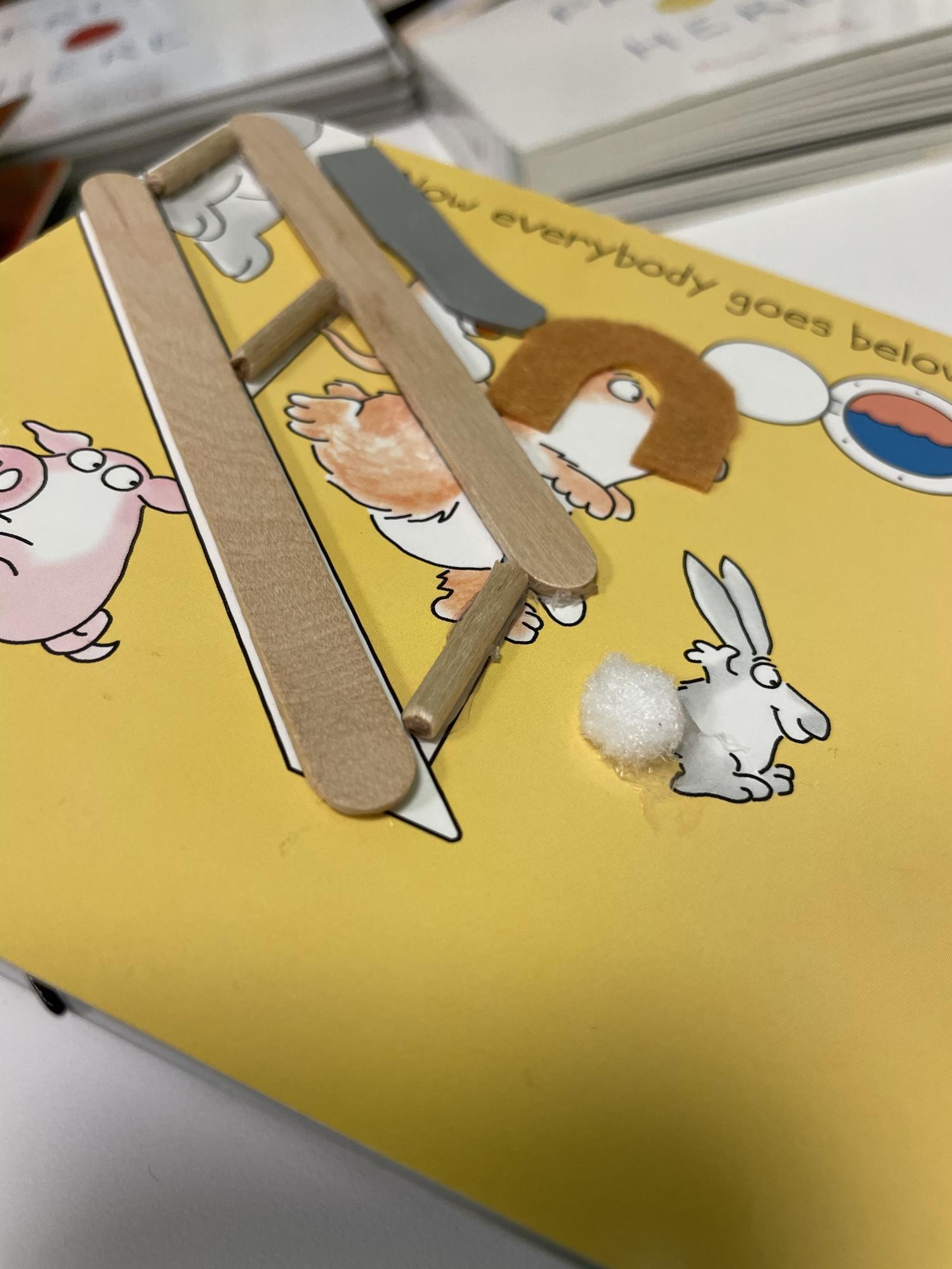 Tactile page with textures for an elephant, lion, and rabbit running downstairs.