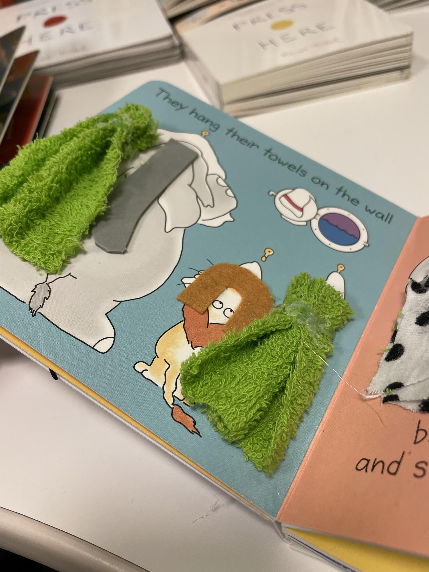 Tactile image with textures for an elephant and lion using towels.