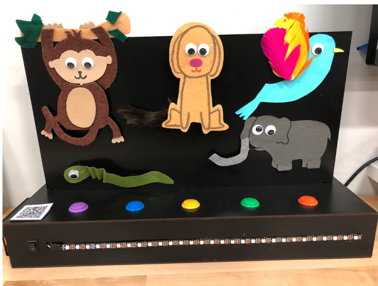 Black box with felt and 3D printed animals of a monkey, dog, bird, snake, and elephant.