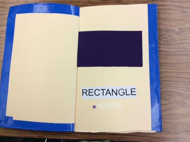 Page showing a large felt rectangle with braille and English label.