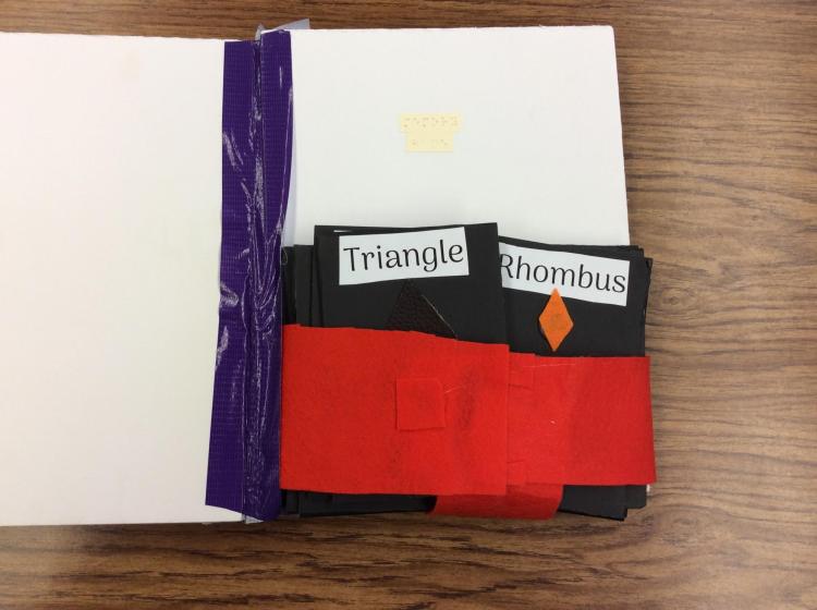 Page with pocket containing large cards with shapes on them for matching game.