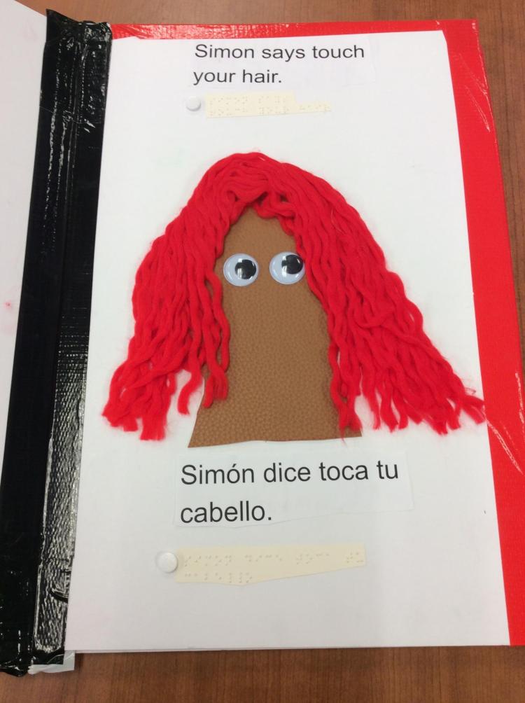 Page showing a head with google eyes and lots of wavy yarn hair.