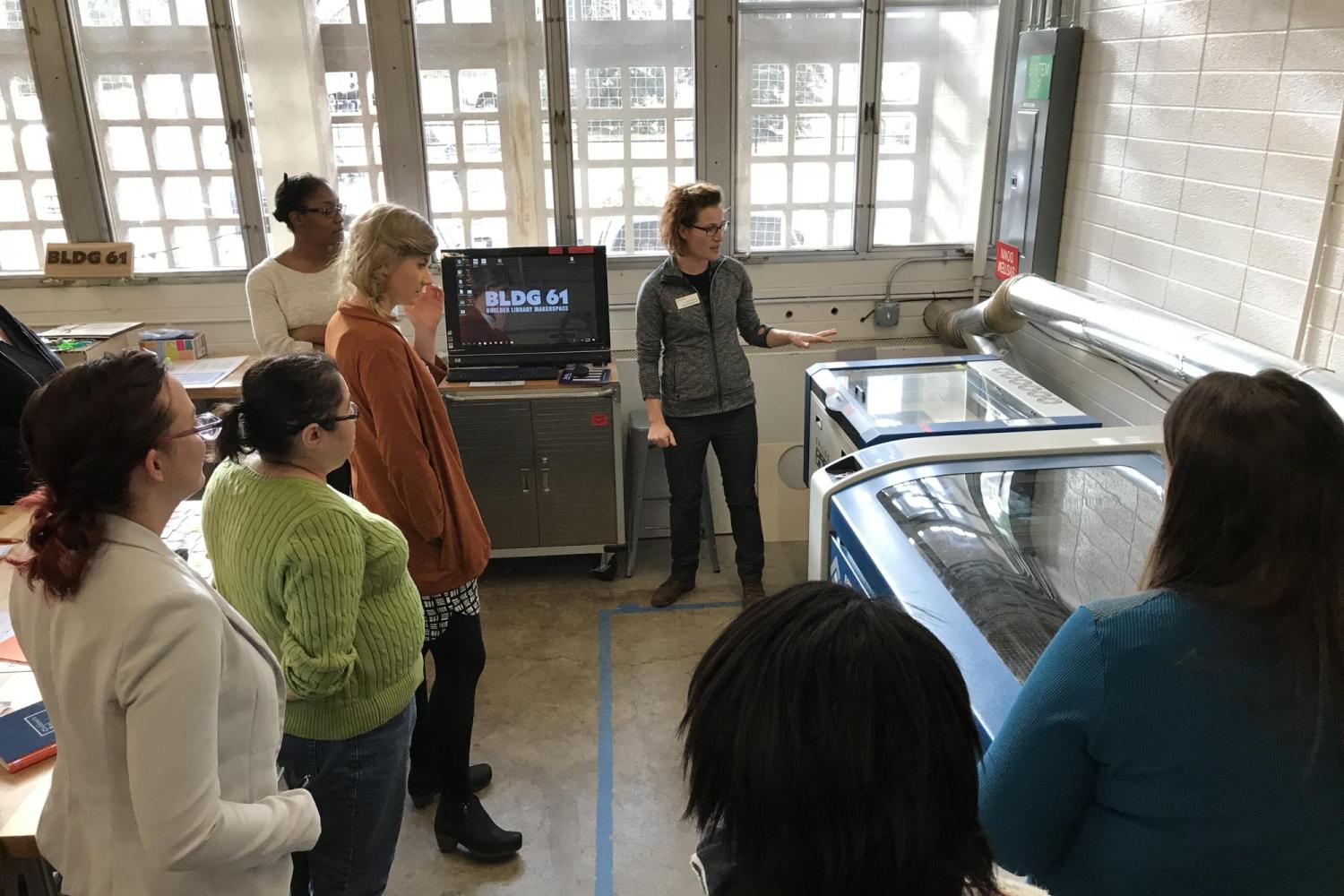 Librarians learn about a laser cutter during PD workshop.