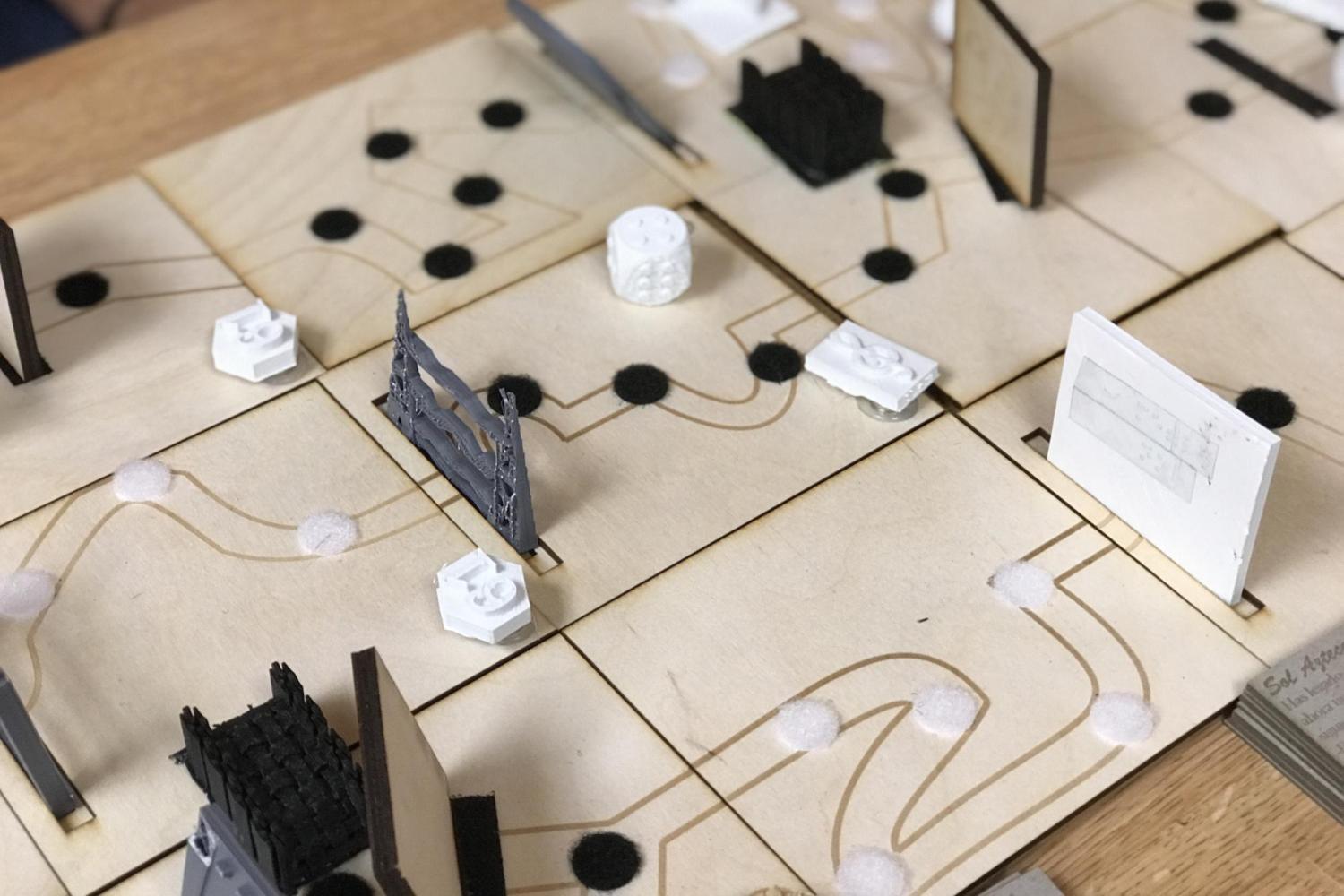 Tactile board game with engraved designs and 3D printed pieces