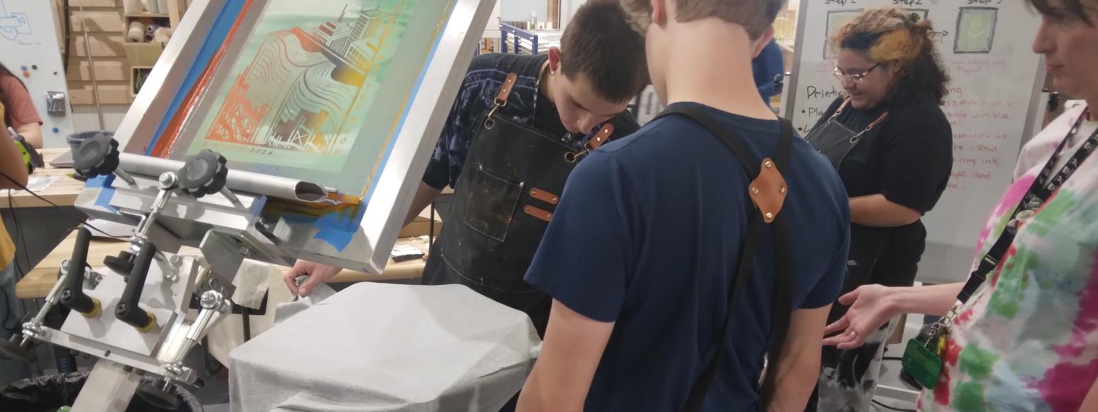 a teen screen printing a BBB shirt