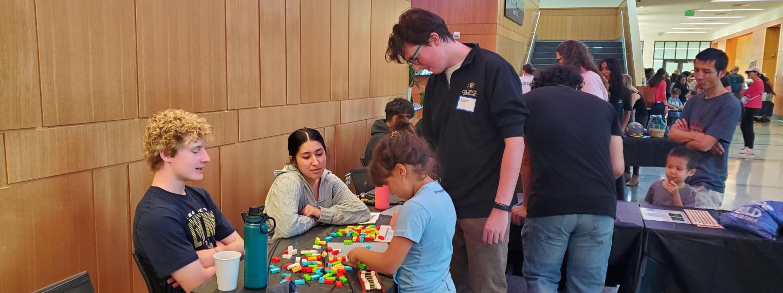 A group of people at a Build a Better Book table