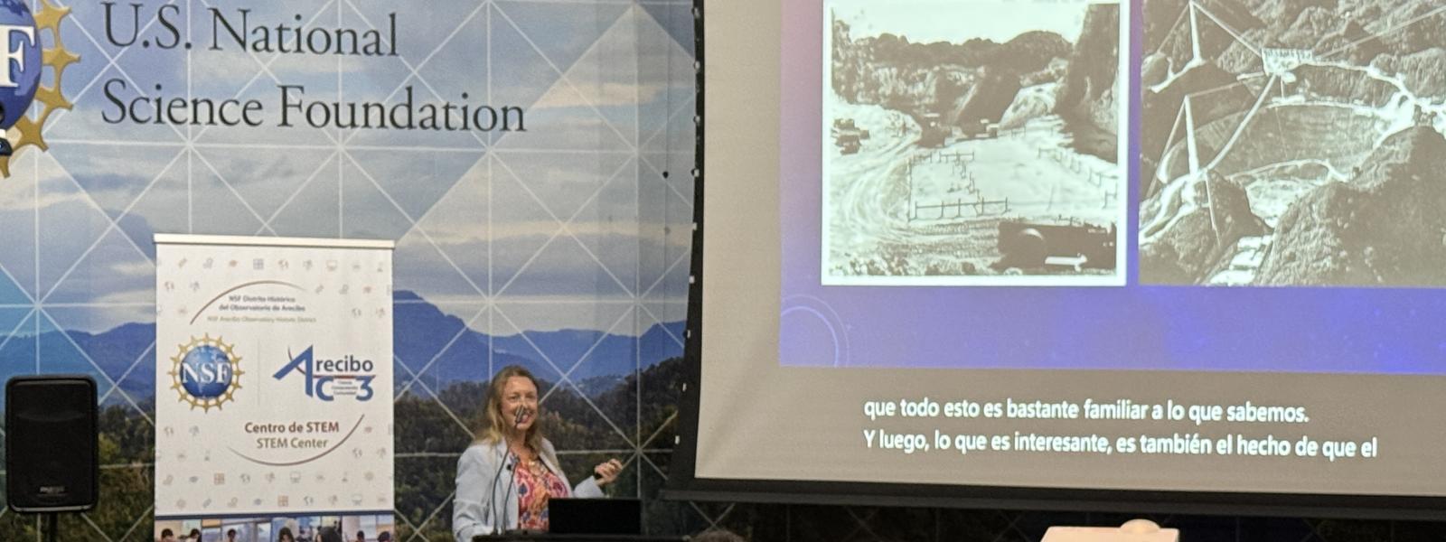 A group of people looking at a large screen of the old observatory telescope.