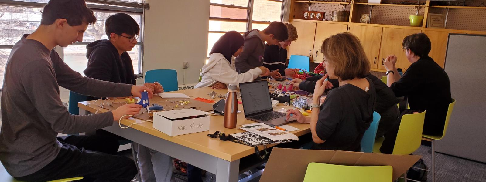 A group of teens working on projects