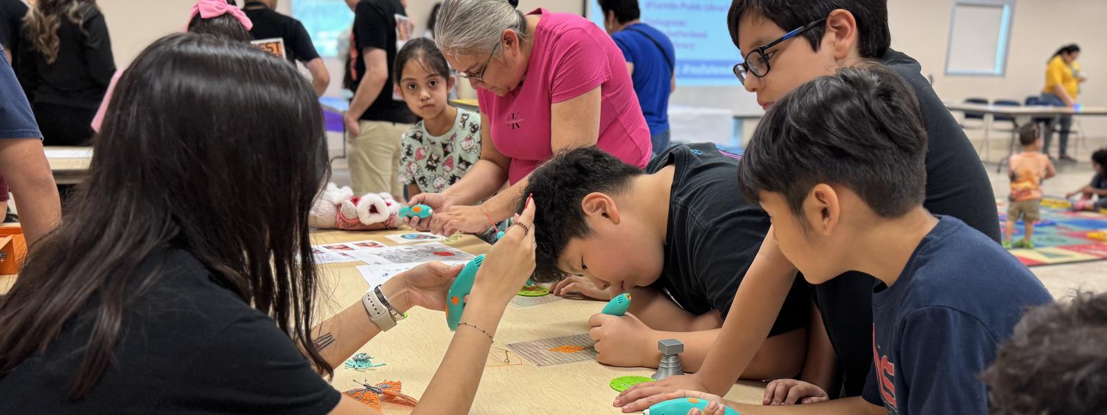 children working with 3d printer pens
