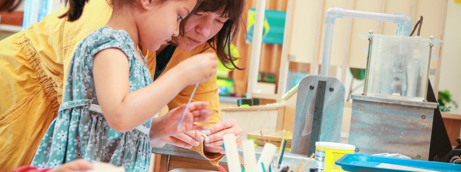 An Adult and Child crafting