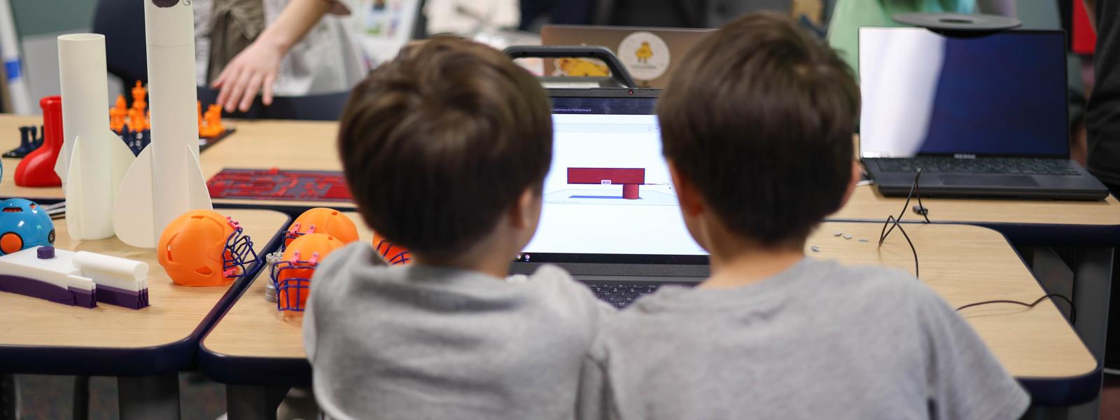 Two young children at a computer