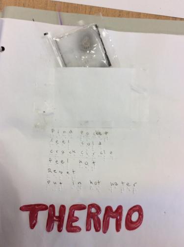 Page with braille instructions for breaking a small heat pack to experience thermoreceptors.
