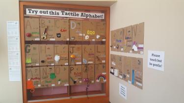 Tactile alphabet display of pages.