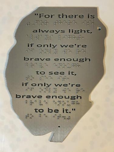 3D Printed silhouette of Amanda Gorman with text and braille poetry lines.