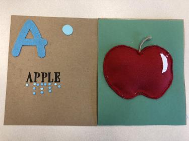 Book page for letter A showing a red felt apple.
