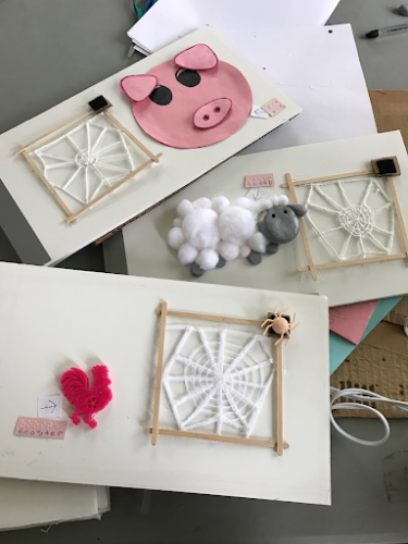 Three pages from The Very Busy Spider showing spider web, pig, sheep, and rooster.