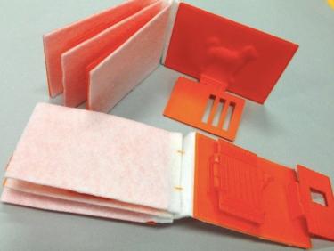 3D printed pages for Dear Zoo mounted on a felt binding. Page shows an open container door with camel behind.