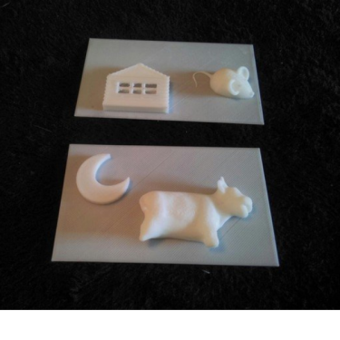 3D printed tactile page of house, mouse, moon, and cow.
